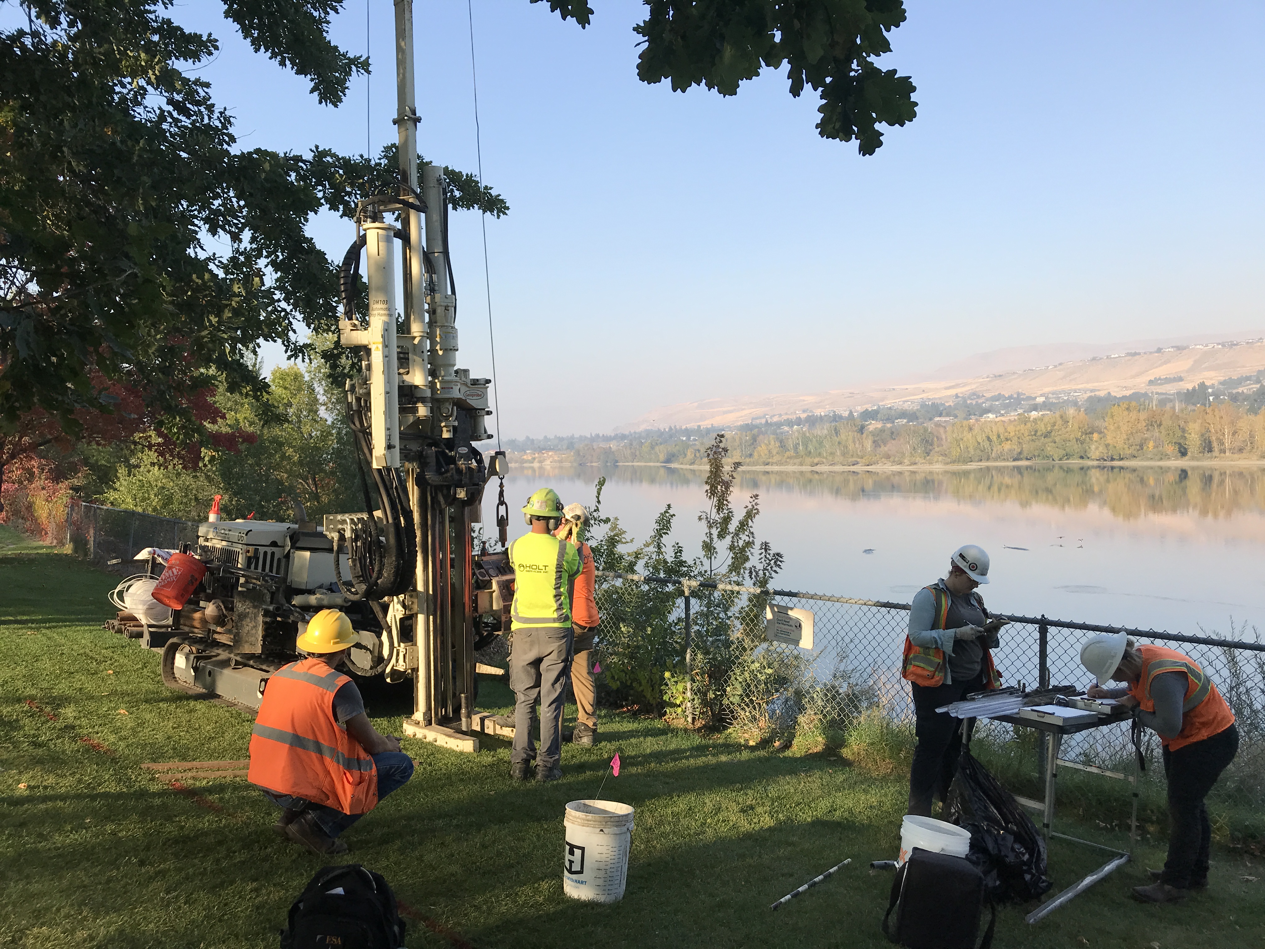 Workers working near body of water