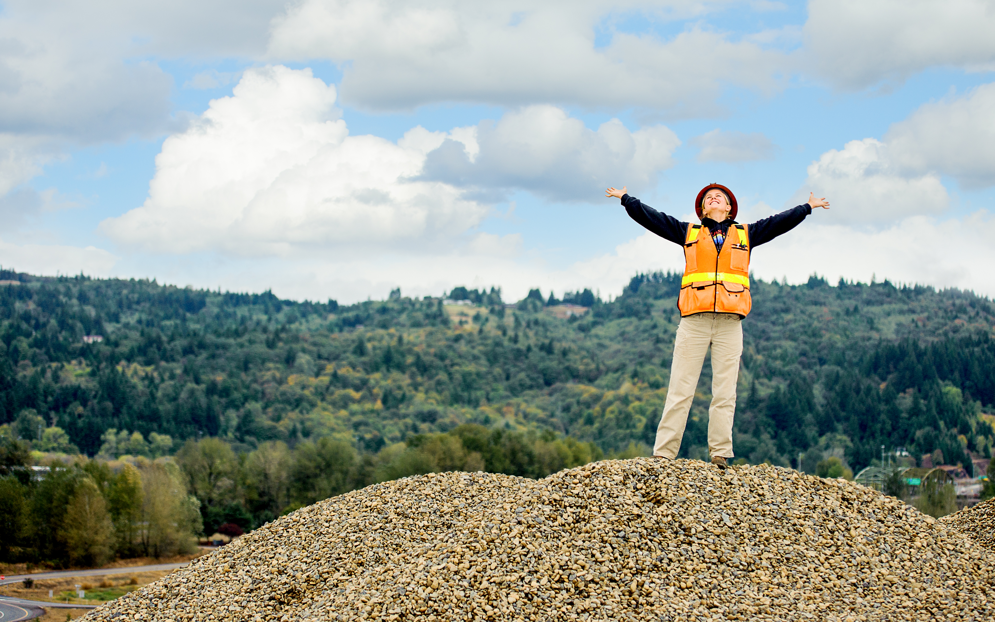 Woman Standing on Top of Gravel Pile