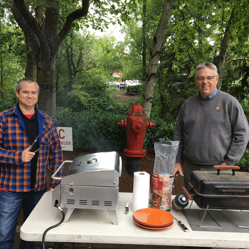 Two people grilling food.