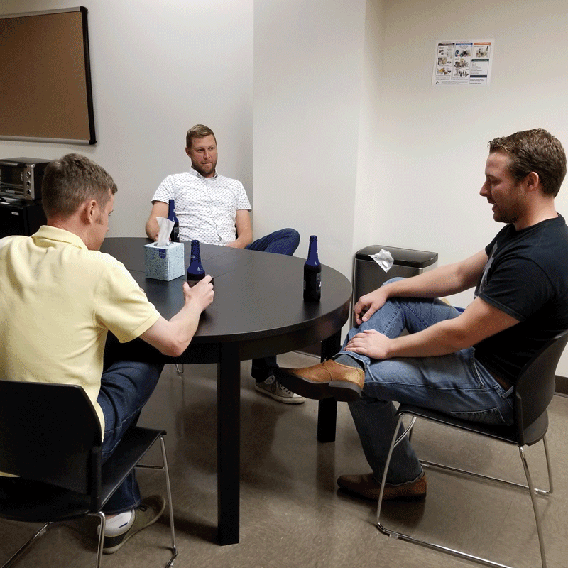 Three people sitting at a table.