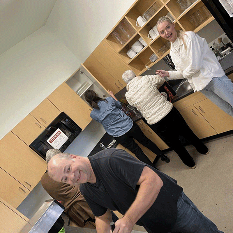 Group of people in a kitchen.