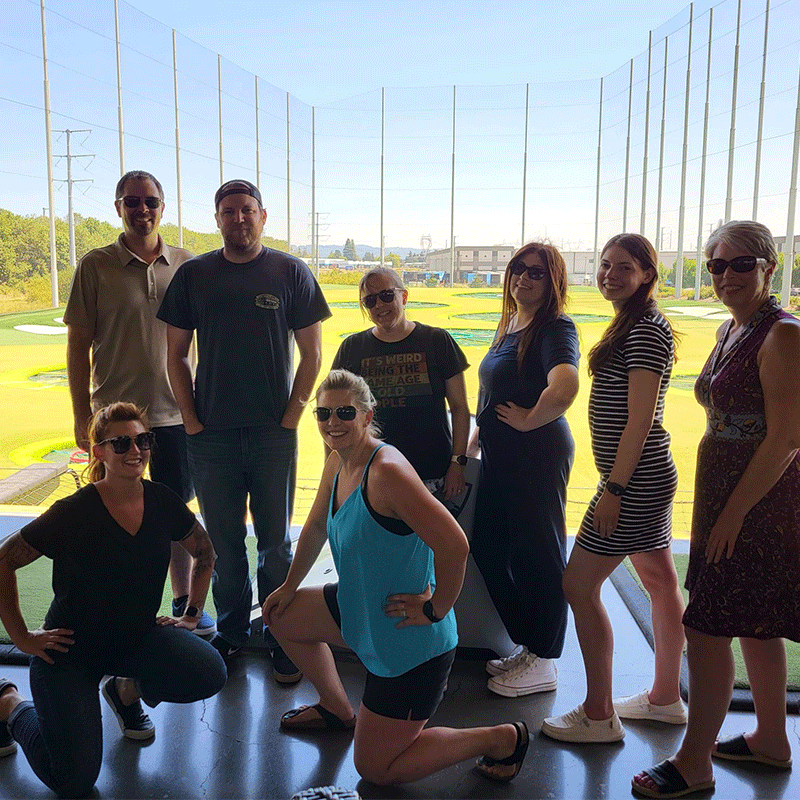 Group of people at a golf course.