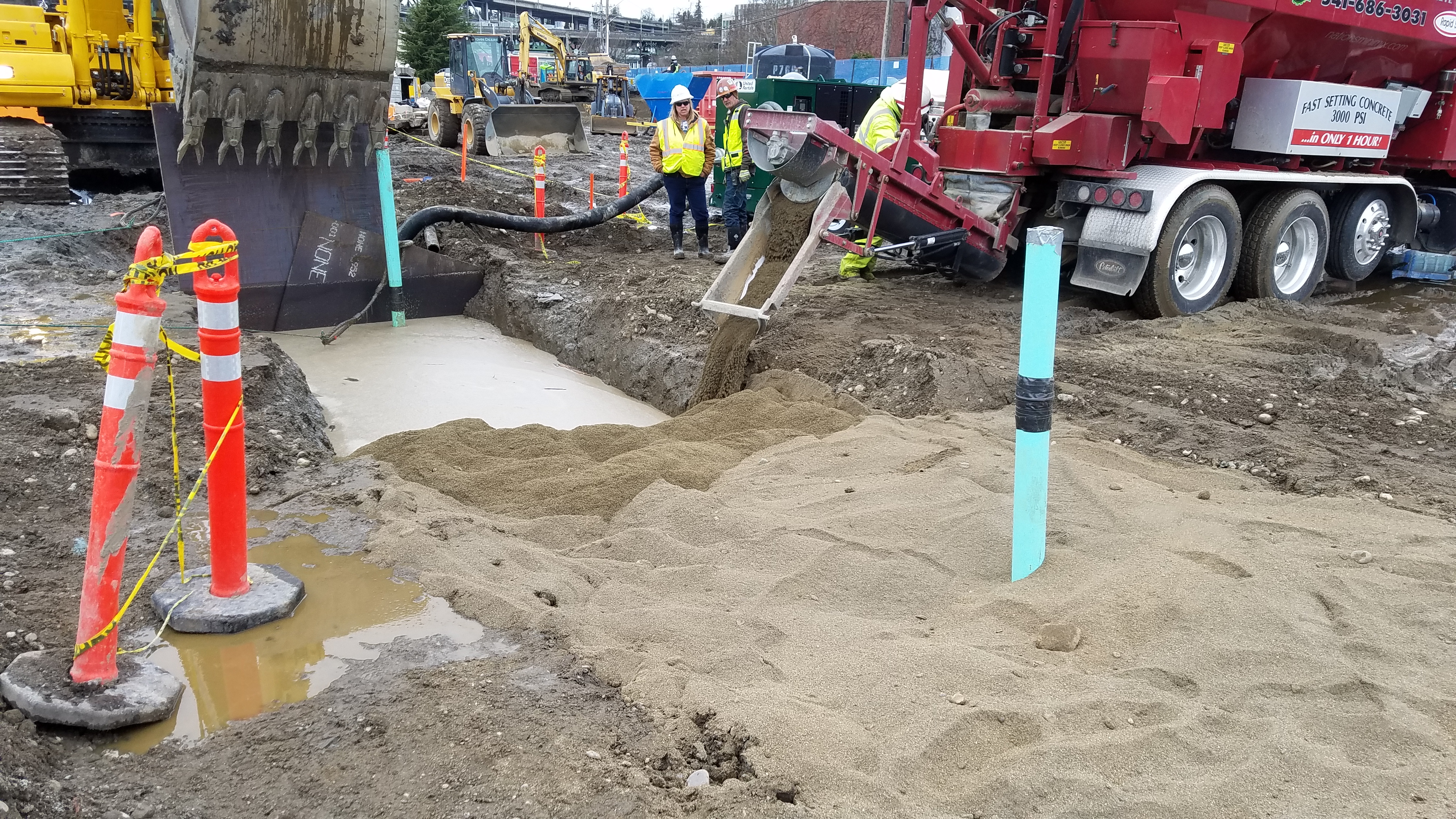 Placing the permeable reactive barrier wall—a blend of sand and zero-valent iron.