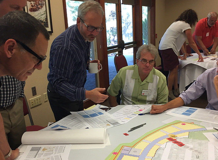 Members of the public looking over plans on a table.