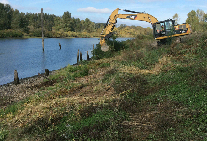 excavator on bank of river