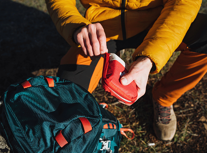 hiker opening a first aid kit