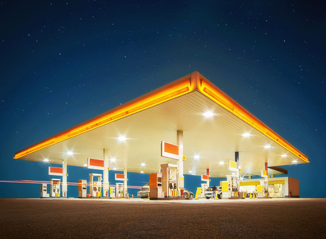 Illuminated gas station at night