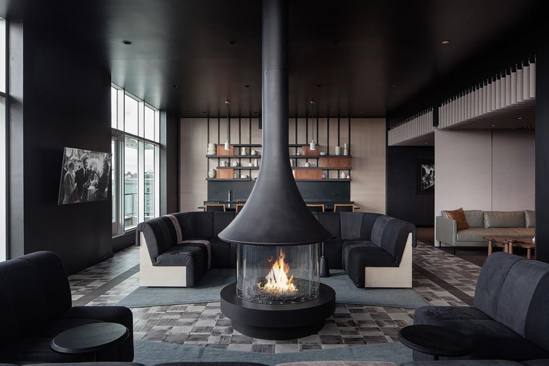 a lounge with fireplace in the center